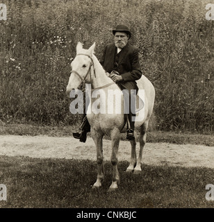 Old Man Riding a Speckled White Horse Stock Photo