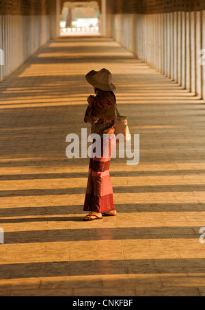 Burmese woman in the corridor at Shwezigon Pagoda, Bagan. Burma. Model Released. Stock Photo