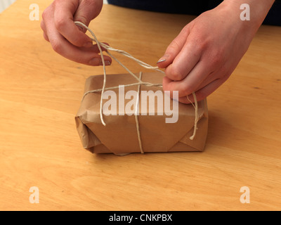 Tying Knot In String Around A Parcel Stock Photo