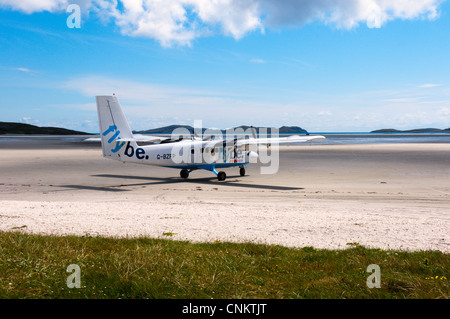 A plane of Flybe - Loganair about to take off from the beach airstrip on the island of Barra in the Outer Hebrides Stock Photo