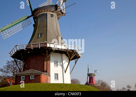 Greetsieler Zwillingsmuehlen windmills, two historic windmills in the resort town of Greetsiel, East Frisia, Stock Photo