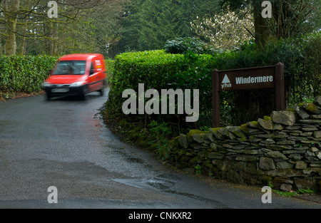 Blurred Royal Mail van delivering to Windermere Youth Hostel, Troutbeck, Lake District National Park, Cumbria, England UK Stock Photo