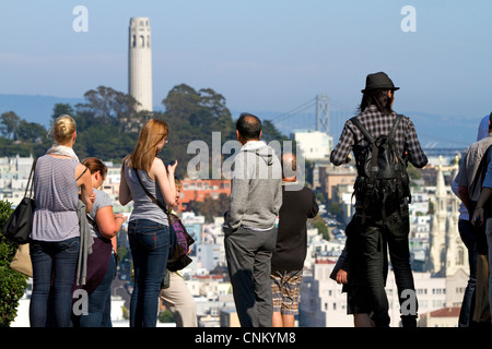 Tourists view Coit Tower located on Telegraph Hill in San Francisco, California, USA. Stock Photo