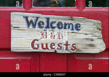 A welcome sign for a bed and breakfast on the front door. Stock Photo