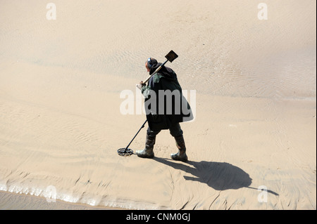 Man using metal detector on the beach at Blackpool England Uk Stock Photo