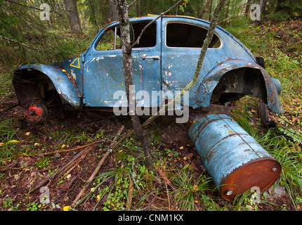 Volkswagen beetle wreck in the forest , Finland Stock Photo