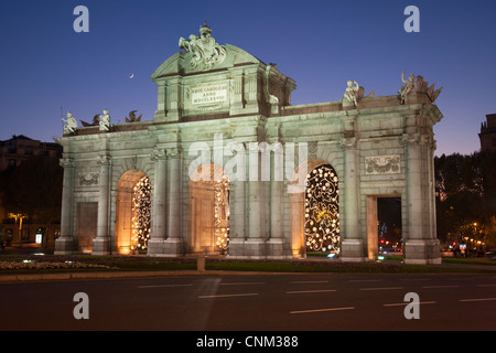 Puerta de Alcalá 'Alcalá Gate Plaza de la Independencia Madrid, night time with Christmas lights and half moon. Stock Photo