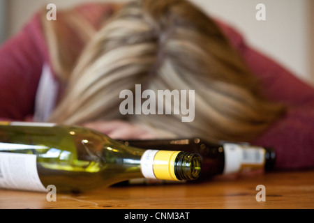 Young blonde alcoholic woman drunk, with empty bottles of alcohol, UK ...