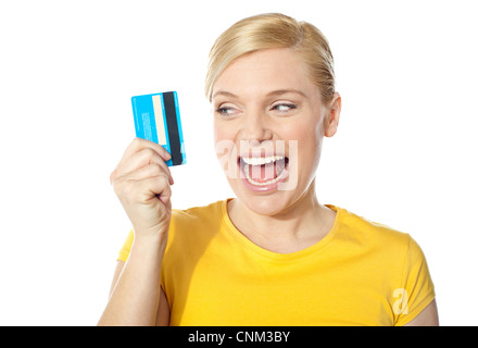 Excited young girl holding debit-card isolated over white background Stock Photo