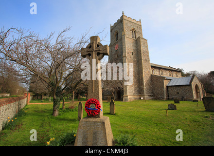 The church of St. Mary's at Brancaster with a wreath of poppies on a war memorial for the 1st World War. Stock Photo
