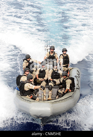 US Navy sailors assigned to the Visit, Board, Search and Seizure team operate in a rigid hull inflatable boat April 12, 2012 in the Indian Ocean. Stock Photo
