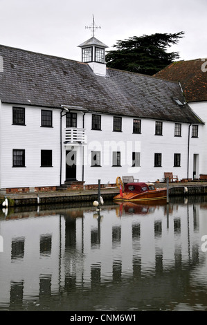 Graphic photo of a row of terraced white cottages on the weir at Hambleden with strong reflections in the River Thames. Old wood Stock Photo