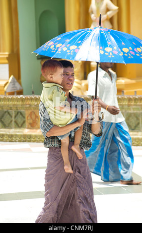 Burmese man with child visiting Shwedagon Pagoda, Rangoon, Burma Stock Photo