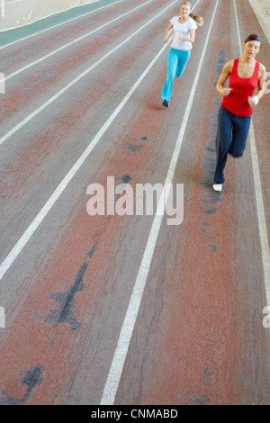 Blurred image of two girls running in gym Stock Photo