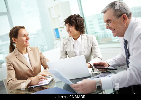 Business group of diverse age discussing some matters, tilt up Stock Photo
