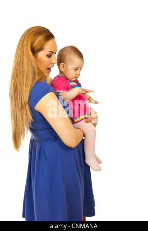 Profile of mother holding baby girl looking away at something and being amazed Stock Photo