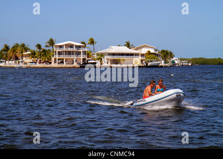 Florida Upper Key Largo Florida Keys,Largo Sound,adult adults man men male,woman women female lady,couple,motorized dinghy,yacht tender,boat,waterfron Stock Photo