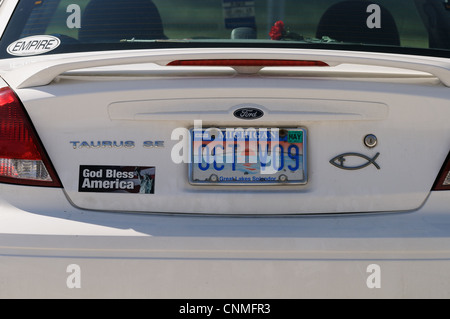 State of Michigan car, automobile, with messages, stickers and red flower,  on a parking place at Fort de Soto park, Florida, US Stock Photo