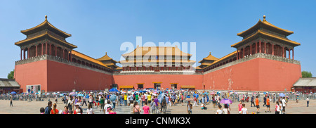 A 3 picture stitch panoramic of crowds of tourists on their way through the Meridian Gate, the entrance to The Forbidden City. Stock Photo