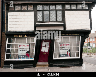 Old King's School shop with crooked red door and windows to let in Canterbury, Kent, UK Stock Photo