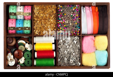 Assortment of different tailoring materials (tape-measure,safety pins,needles,zippers,buttons,spivels,threads and cottons) in vi Stock Photo