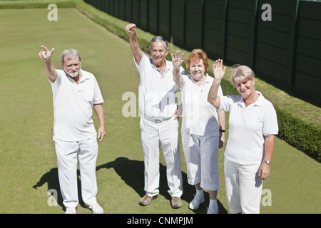 Older people waving from lawn Stock Photo