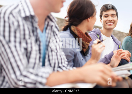 Students studying together outdoors Stock Photo