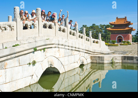 A group of European tourists on a bridge in the courtyard and pavillion in front of Yuling, the Tomb of Emperor Qianlong. Stock Photo