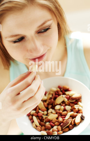 Girl eating nuts Stock Photo