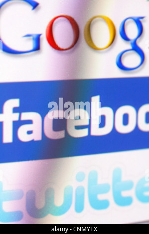 Google, facebook and twitter logos on a monitor screen Stock Photo