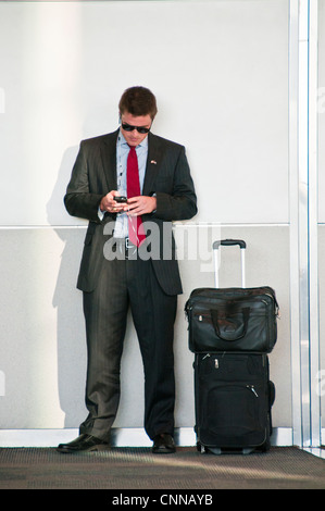 young businessman texting smart phone Stock Photo