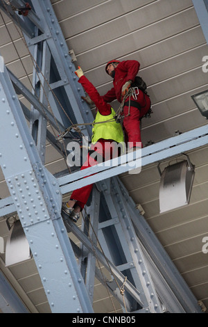 Workmen in the roof at Saint  Pancras Station in London Stock Photo