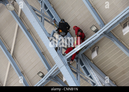 Workmen in the roof at Saint  Pancras Station in London Stock Photo