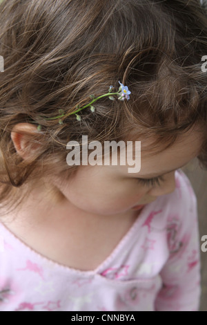 A close up of a flower in a little girl's hair. Stock Photo