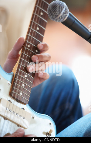 Close up of man playing guitar Stock Photo
