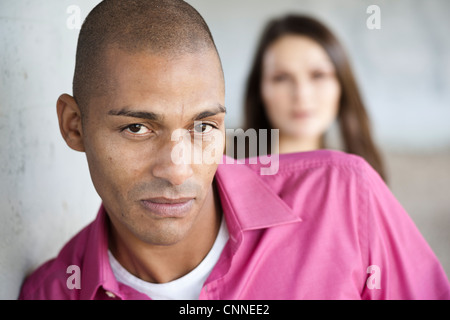 Portrait of Man with Woman in Background Stock Photo