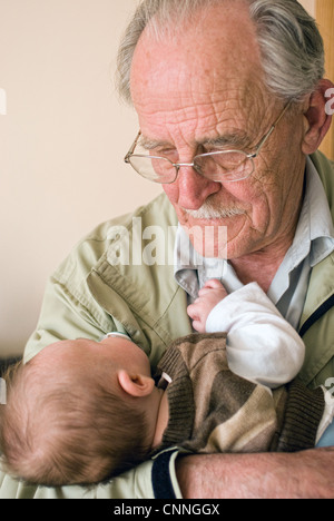 A grandfather holds his infant grandson Stock Photo