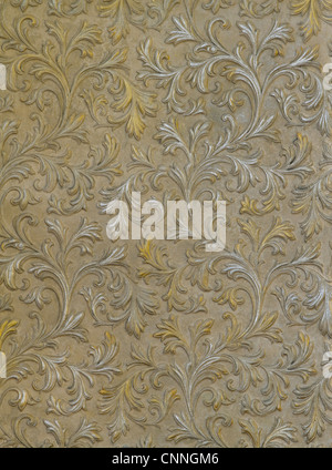 fragment of the cement wall with the silver and gold leaves Stock Photo