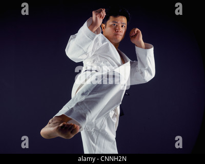 Man practicing martial arts Stock Photo