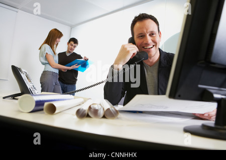 Businessman talking on phone at work Stock Photo