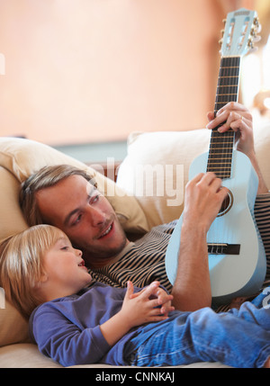 Father and son playing ukulele Stock Photo