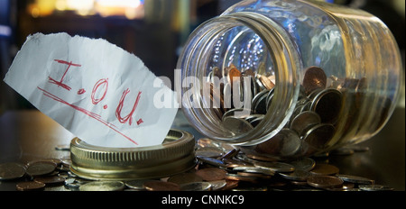 Mason Jar with Coins and IOU Note Stock Photo