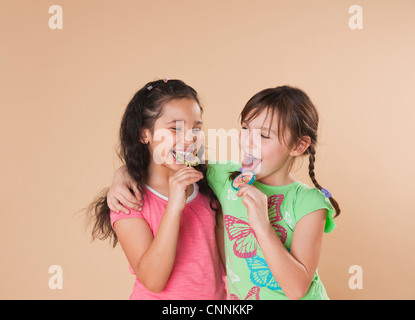 Portrait of Girls Eating Candy Stock Photo
