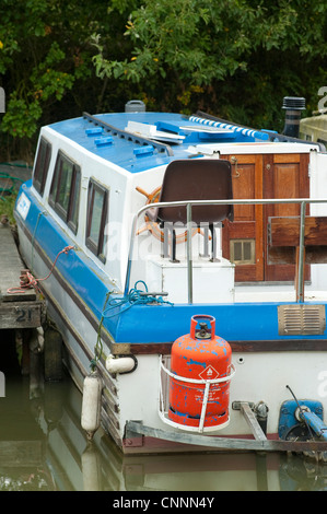 Boat moored in a marina carrying bottles of propane gas. Stock Photo