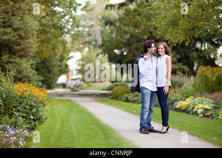 Portrait of Young Couple Standing on Walkway in Park, Ontario, Canada Stock Photo