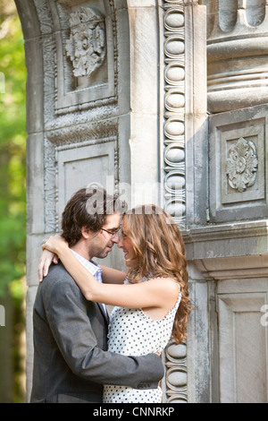 Young Couple Embracing in Park Stock Photo