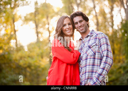 Portrait of Young Couple in Park Stock Photo
