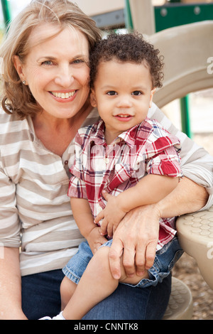 Portrait of Young Boy and Grandmother at Playground Stock Photo