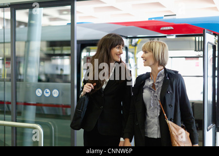 Businesswomen walking in bus station Stock Photo