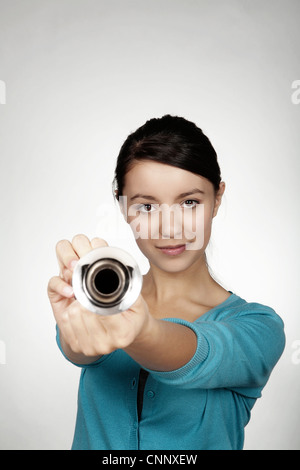 cute young woman holding a bicycle horn making some noise Stock Photo